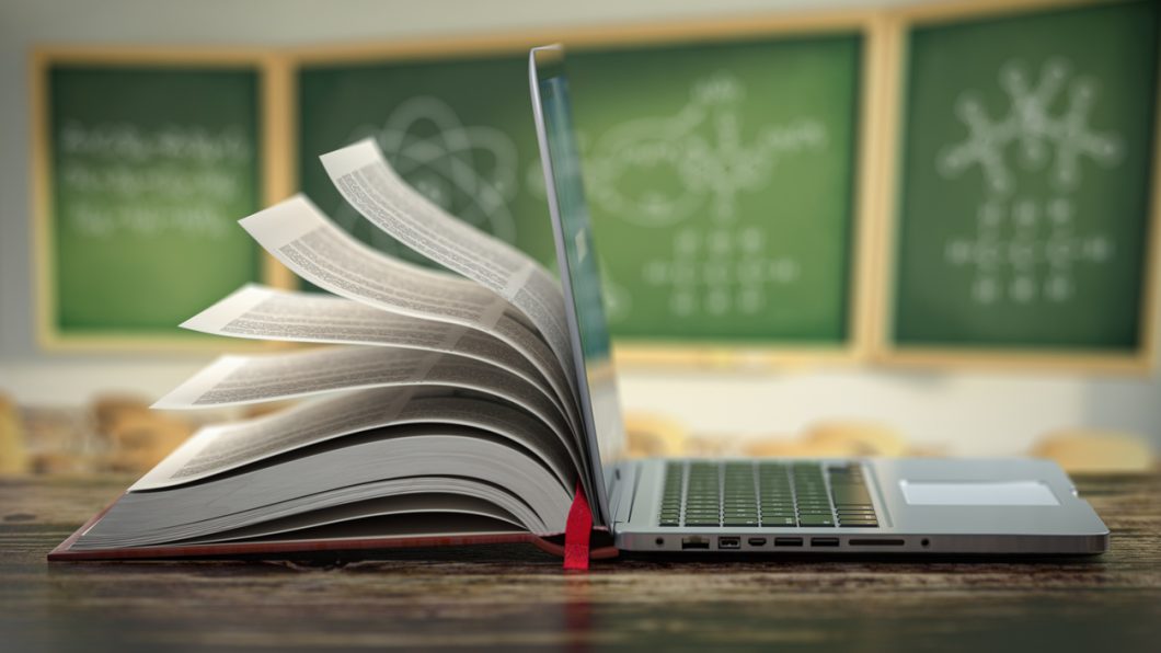 E-learning online education or internet  encyclopedia concept. Open laptop and book compilation in a classroom. 3d illustration